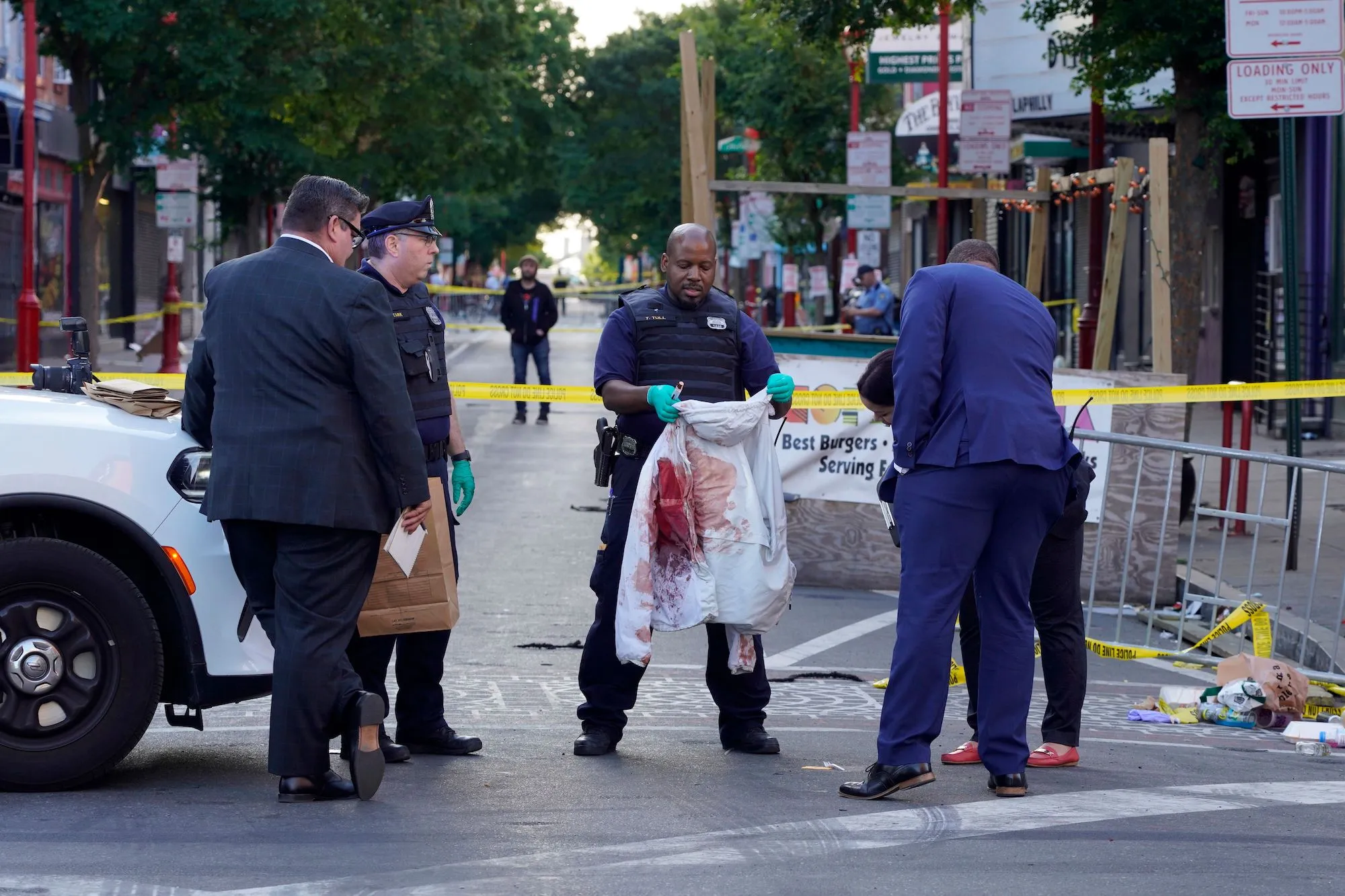 Officers stand near the scene of a mass shooting in Chattanooga on Sunday