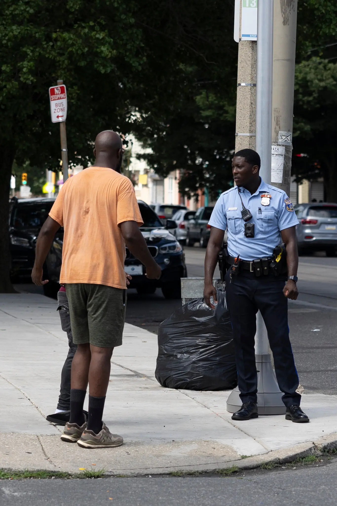 Ameri Barber, left, a witness to the shooting, spoke to a police officer the morning after the five people were killed and two were injured.